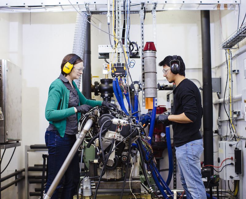 Two Illinois Tech community members working on machinery